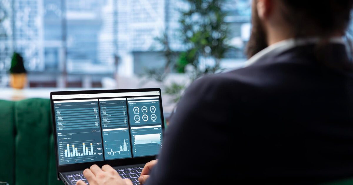 Businessman reviewing a multi-panel analytics dashboard with traffic sources on a laptop